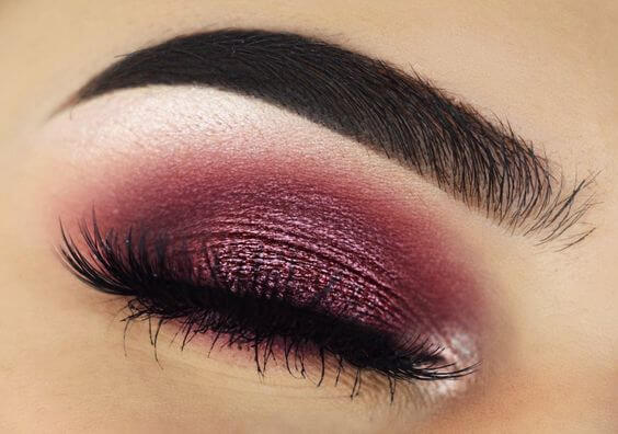Photo of a closed eye with pink eyeshadow over the lid