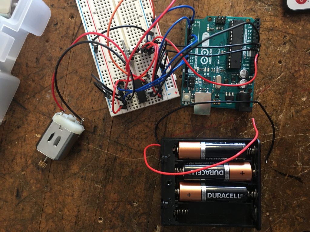Arduino breadboard attached to several AA batteries.