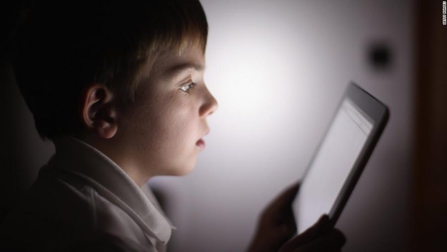 In this photograph illustration a ten-year-old boy uses an Apple Ipad 