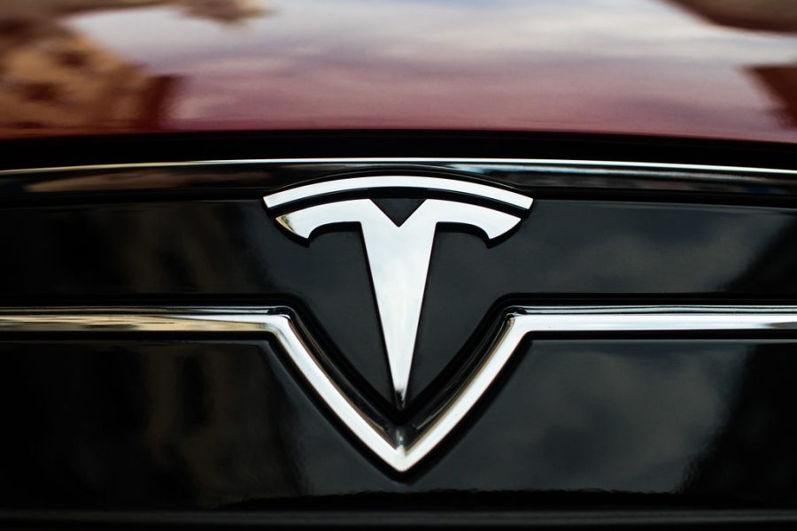 Close-up of TESLA trademark sign on a car by Ivan Radic is licensed under CC BY 2.0