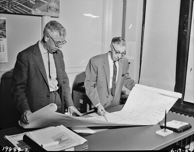 Engineers discussing freeway plans, 1959 by Seattle Municipal Archives is licensed under CC BY 2.0. To view a copy of this license, visit https://creativecommons.org/licenses/by/2.0/?ref=openverse.

