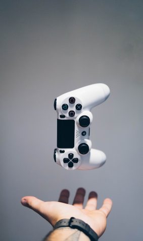white Sony PS4 DualShock controller over persons palm
