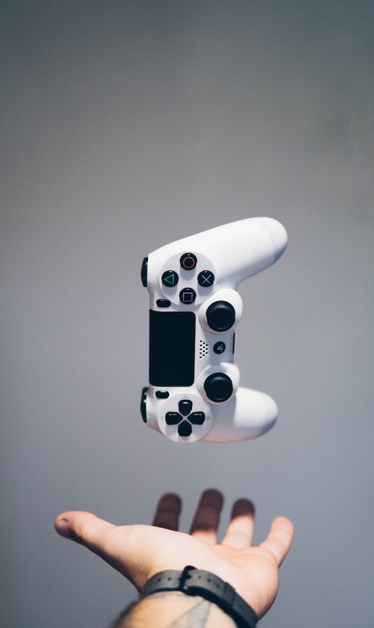 white+Sony+PS4+DualShock+controller+over+persons+palm