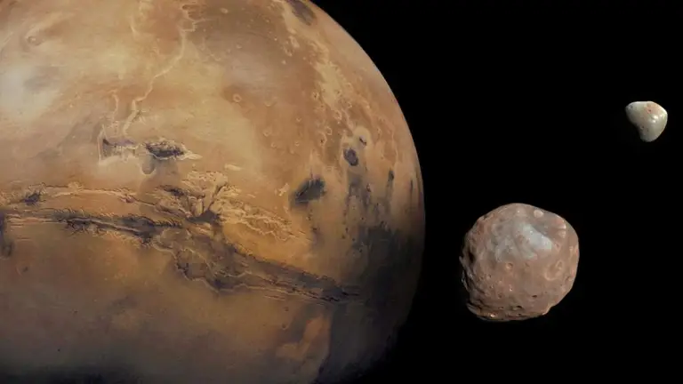 Mars is kept company by two cratered moons -- an inner moon named Phobos and an outer moon named Deimos.