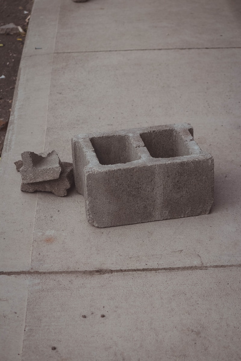 a concrete block sitting on the side of a sidewalk