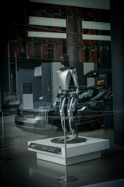 a display case with a suit and a car in it