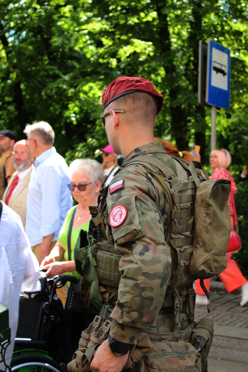 a man in a military uniform standing next to a group of people