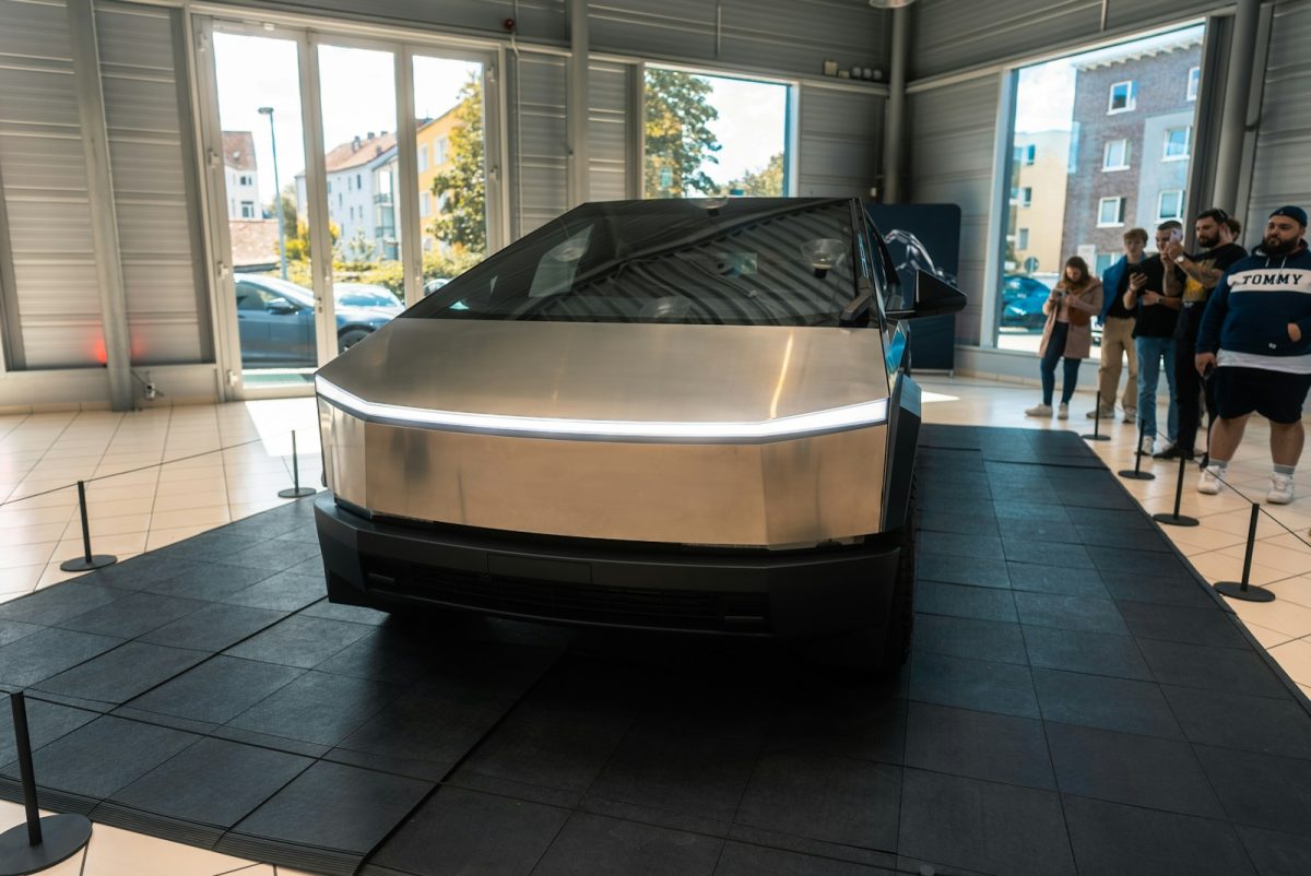 A silver car is on display in a building