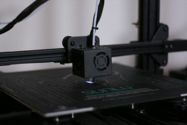 A picture of a 3D printer with wires coming out of it