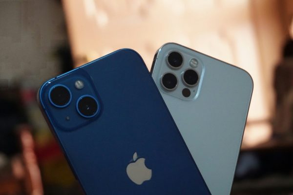 two blue and white iphones sitting next to each other