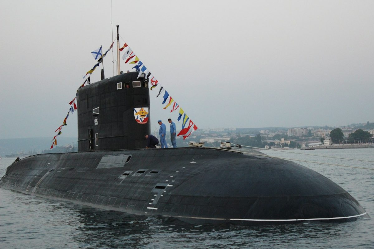 black ship on sea under gray sky during daytime