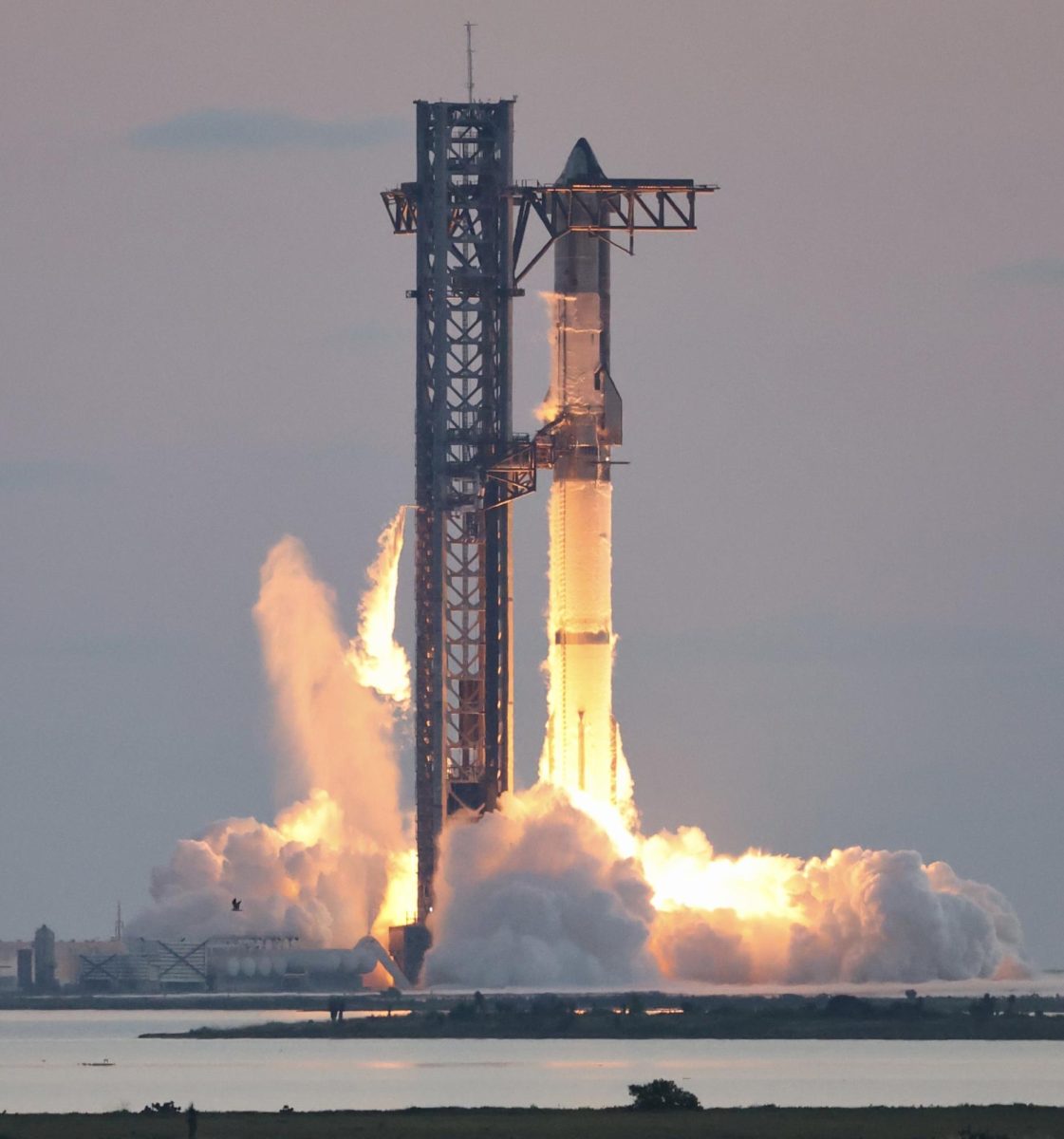 A photograph of Starship lifting off from its launchpad.