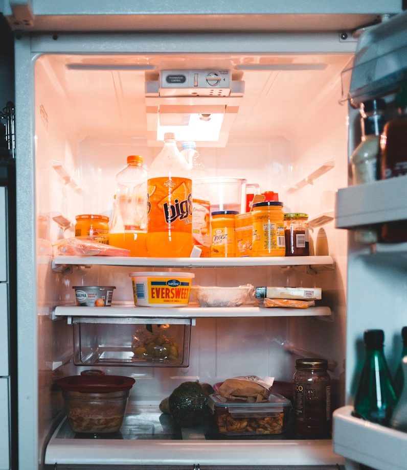 white refrigerator with assorted items