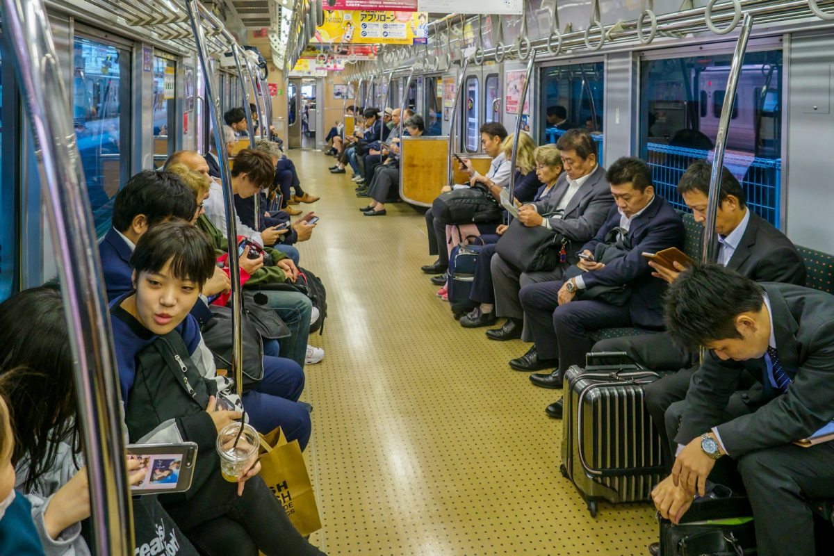 people sitting on black chair inside train